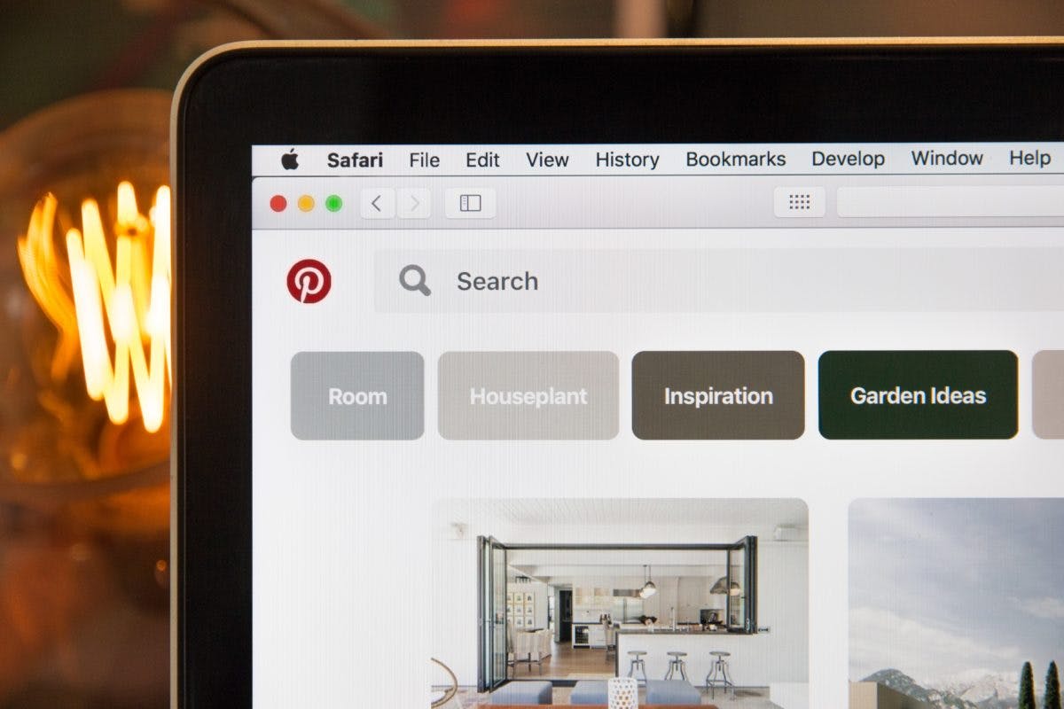 An Apple laptop open to Pinterest and showing the Pinterest keyword tool search bar